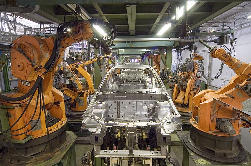 KUKA industrial robots on a factory floor