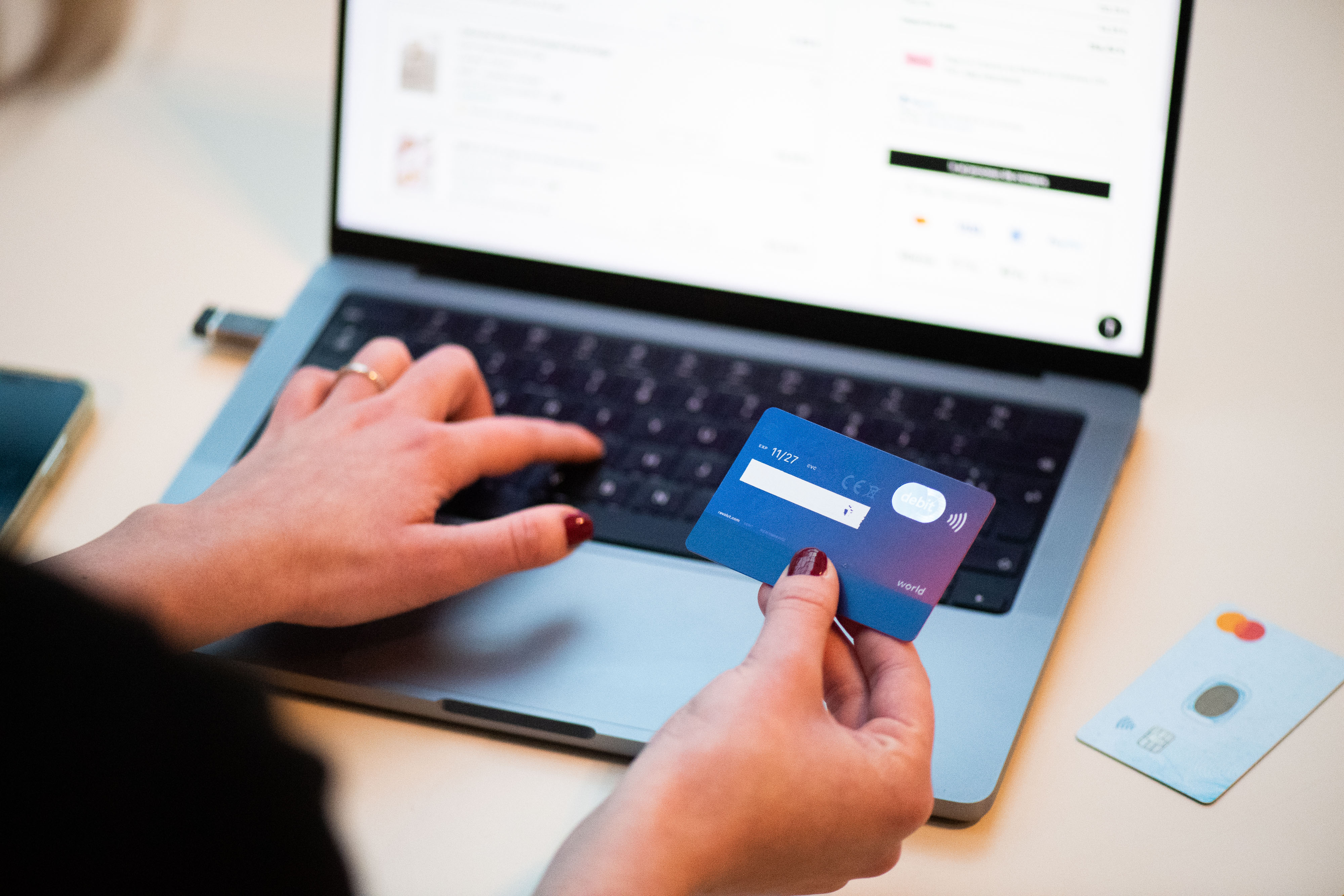 A person using a bank card while shopping online