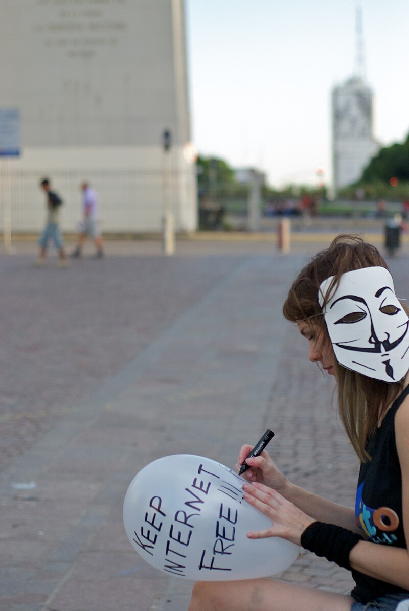 A protester wearing a Guy Fawkes mask at an anti-ACTA demonstration, illustrating how anonymity has been used to enable political speech and protect identity in public life