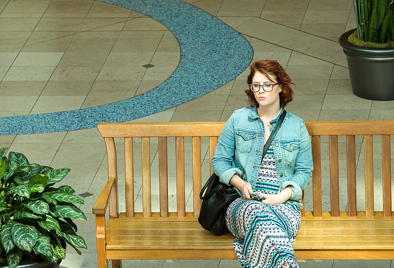 A woman sitting alone on a bench in downtown Portland