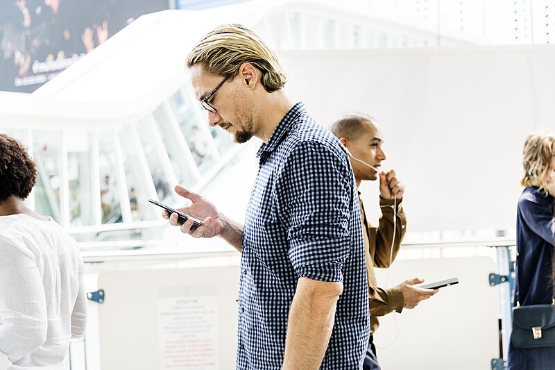 People walking while absorbed in their smartphones